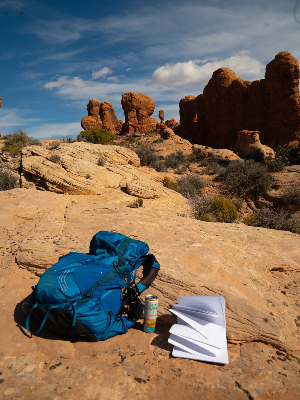 Backpack, notebook and a Sun Cruiser on desert slickrock
